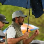 Day handles rain, expands lead at Wells Fargo